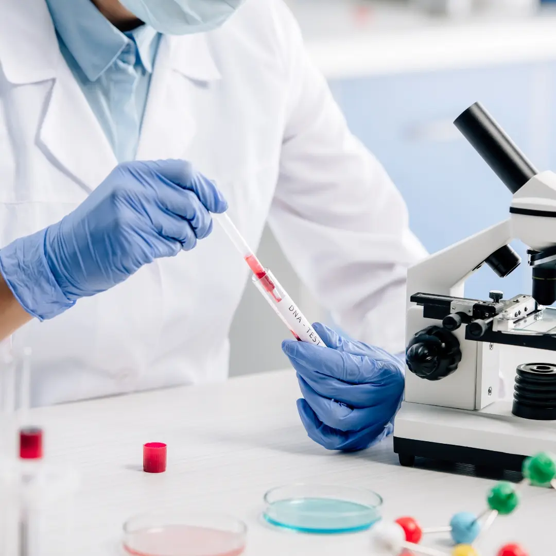 Well Health Labs scientist reviewing a specimen in a laboratory