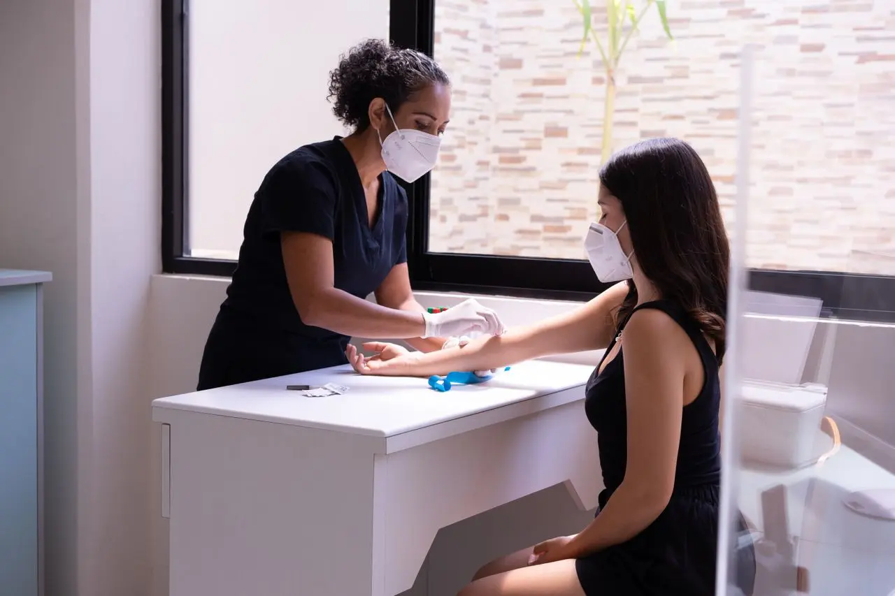 Patient having a blood sample collected at Well Health Labs
