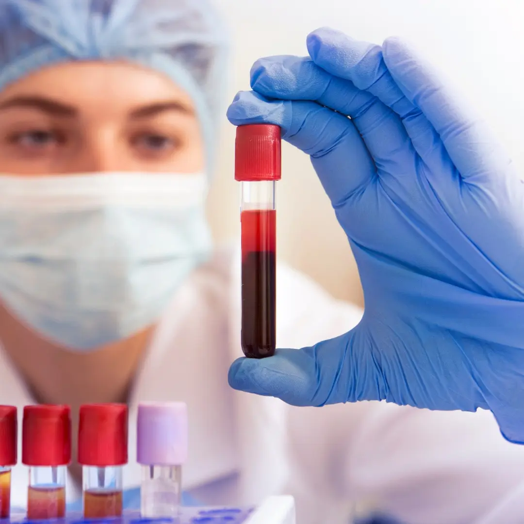 Lab professional reviewing blood test panels at Well Health Labs