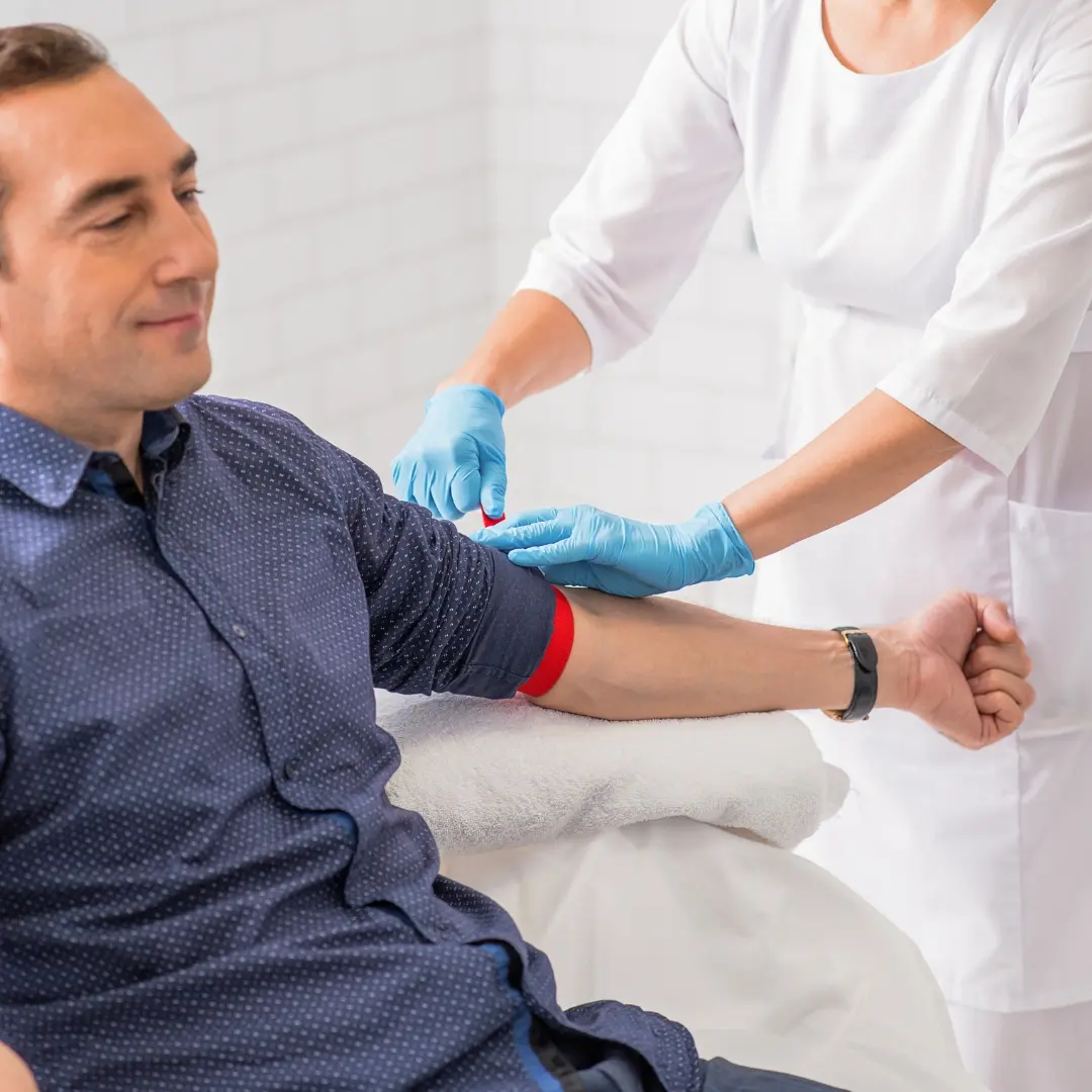 Lab professional reviewing blood test panels at Well Health Labs